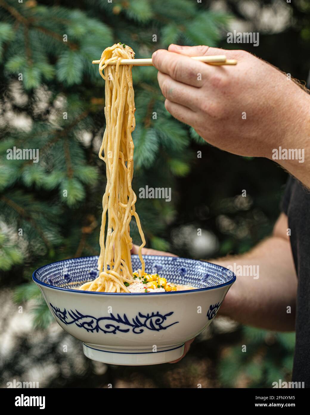 Eating japanese ramen noodles soup with chopsticks Stock Photo