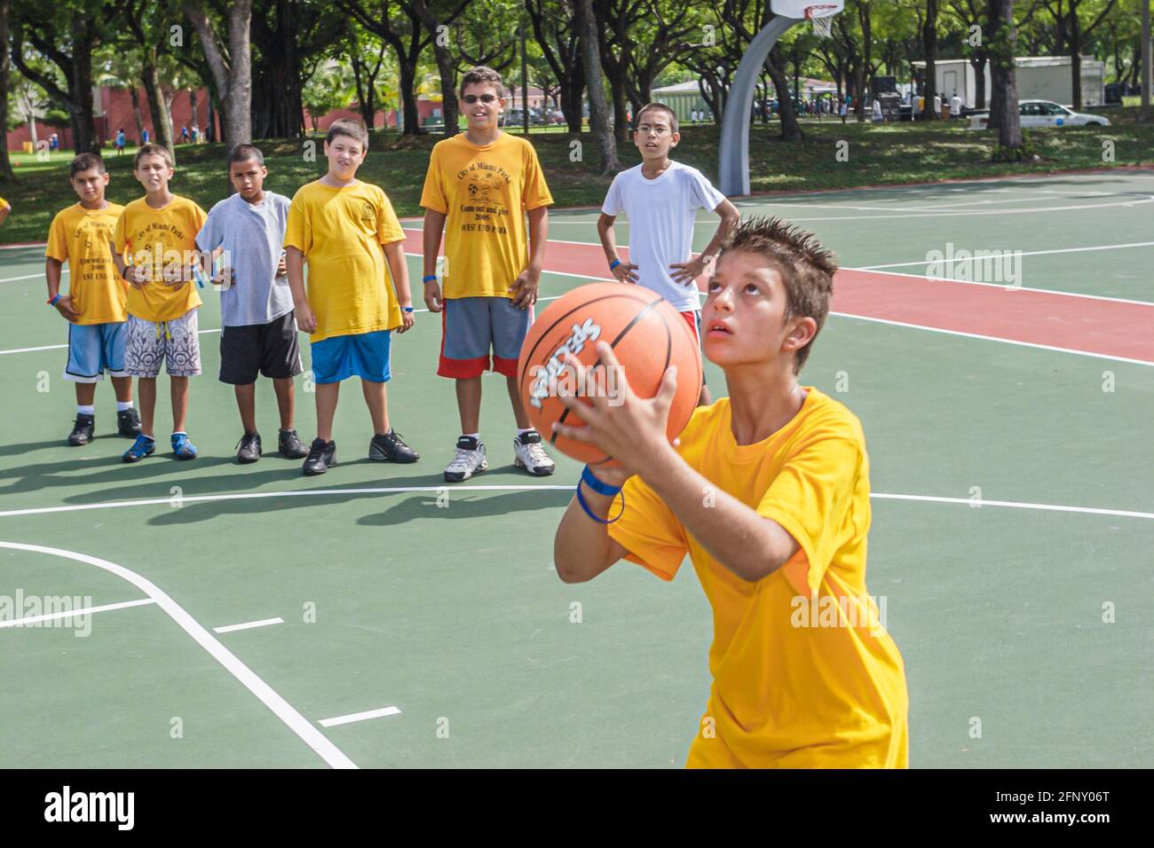 Miami Florida,Hadley Park Dade County Parks Summer Camp Program,Hispanic boy boys kids basketball shooting aiming ball basket, Stock Photo