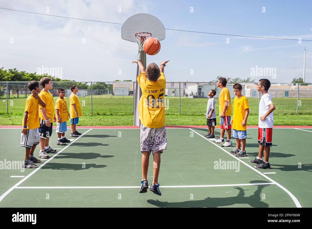 Miami Florida,Hadley Park Dade County Parks Summer Camp Program,Hispanic boy boys kids basketball shooting foul shot ball basket, Stock Photo