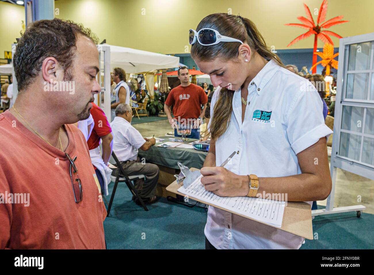 Florida,Miami Beach Convention Center,centre,Home Design & Remodeling Show,Hispanic man woman female taking survey questionnaire answering questions c Stock Photo