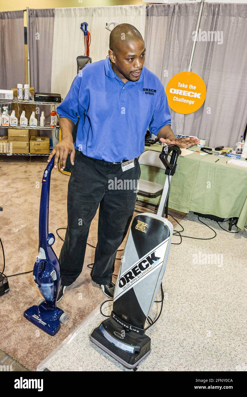 Florida,Miami Beach Convention Center,centre,Home Design & Remodeling Show,Black man male vacuum cleaner salesman selling demonstrating demonstrates O Stock Photo