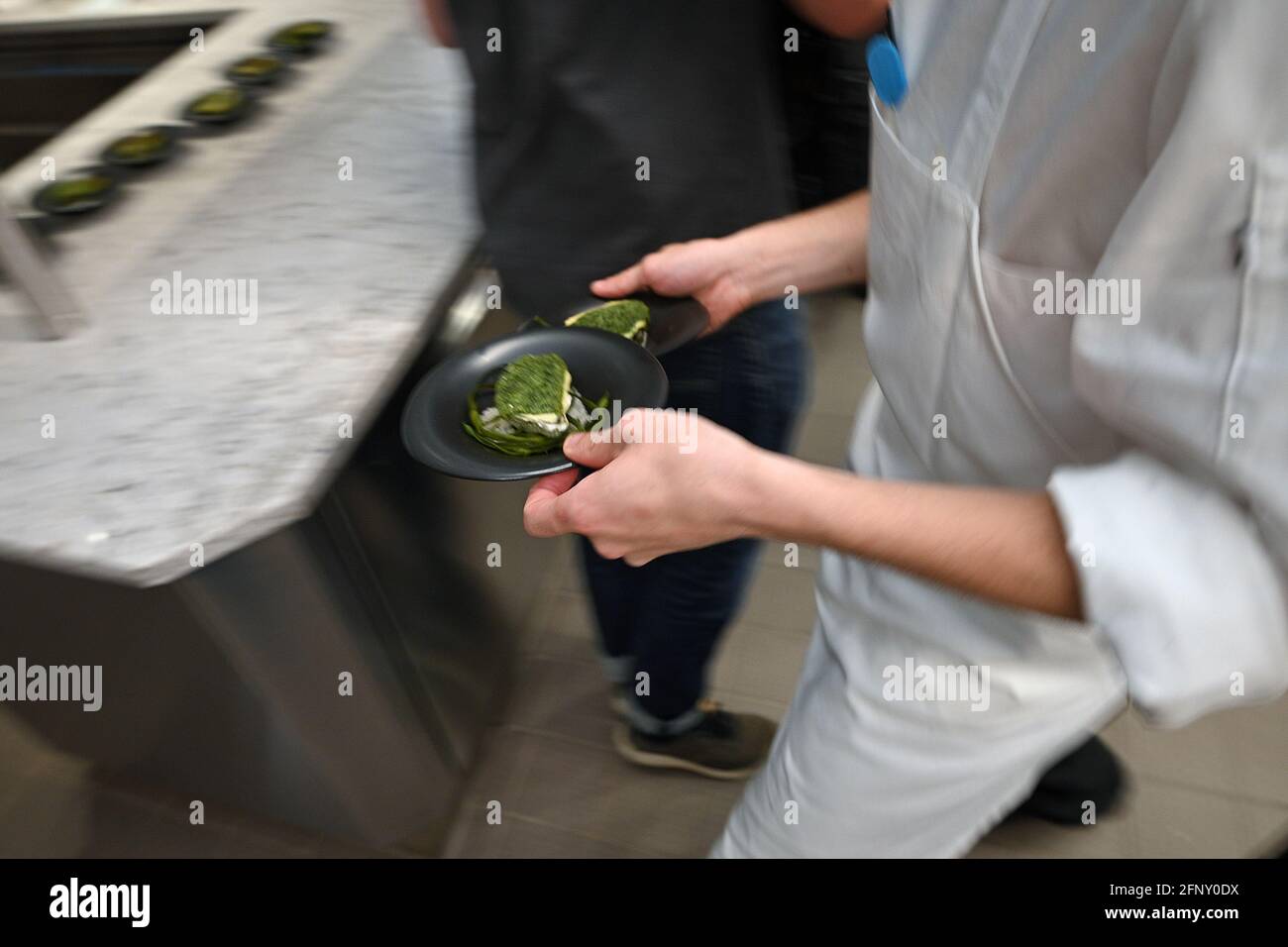 A French chef prepares “oysters Vanderbilt” on opening day of Chef