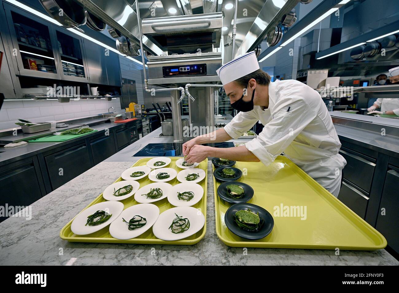 Kitchen staff prepare “oysters Vanderbilt” on opening day of Chef