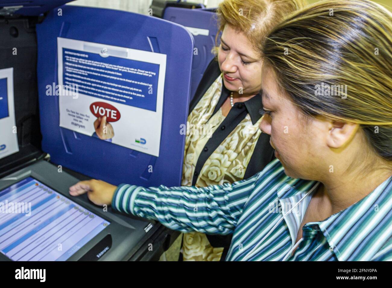 Miami Florida,Sheraton Convention Center centre,electronic voting machine Hispanic women woman female demonstrating exhibit exhibitor,how to use, Stock Photo