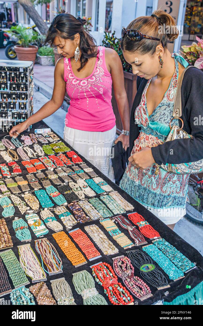 Miami Beach Florida,Espanola Way stalls booth vendor women shopping,marketplace buying selling Hispanic Asian looking woman female jewelry jewellery, Stock Photo