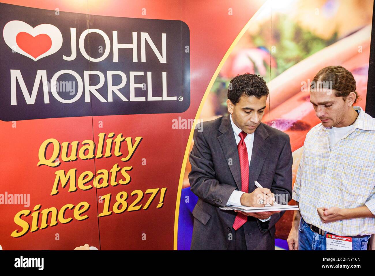 Florida,Miami Beach Convention Center,Americas Food & Beverage Show trade Hispanic men man John Morrell Quality Meats representative,talking customer Stock Photo