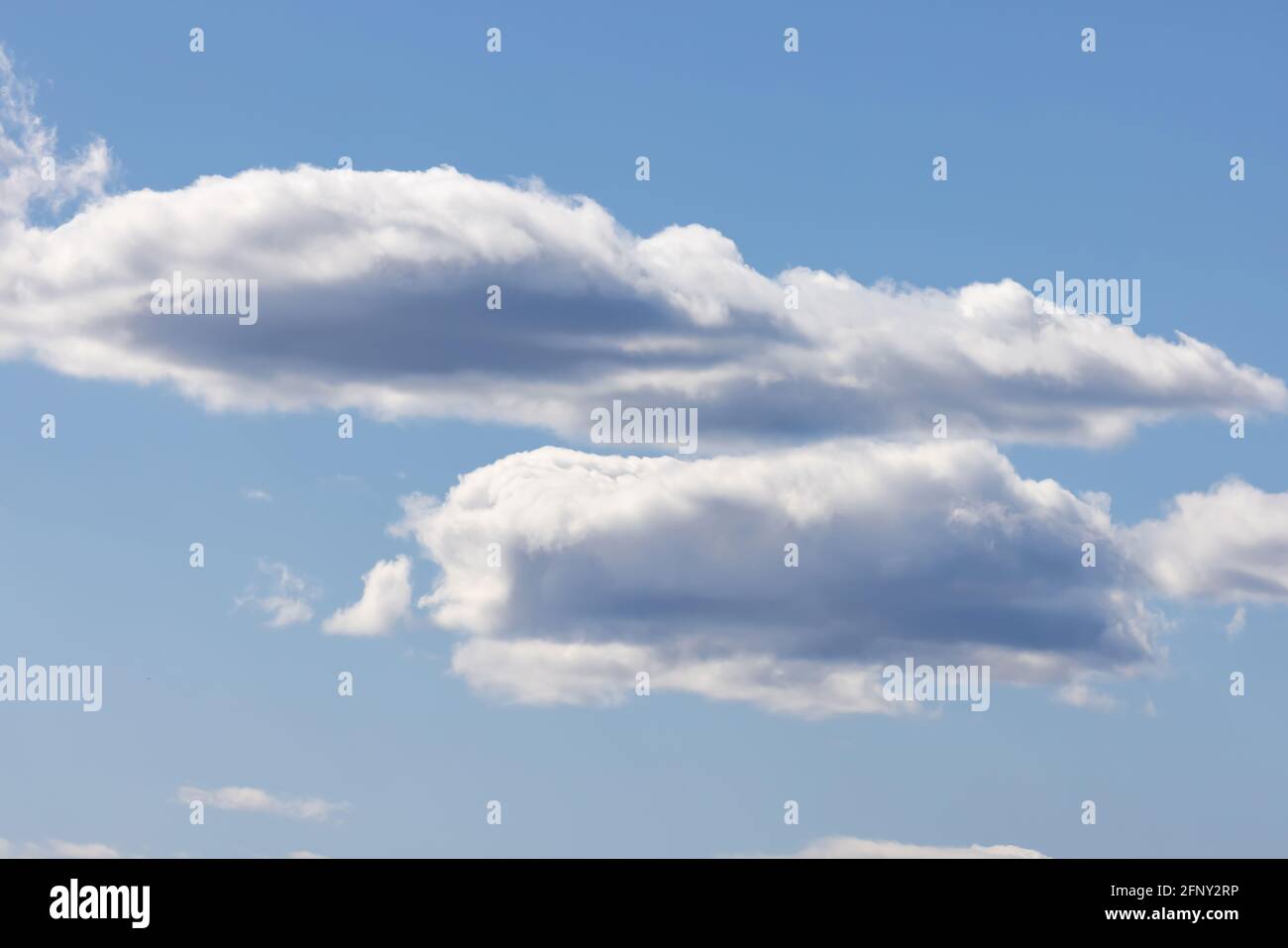 white puffy clouds on a bright blue sky Stock Photo - Alamy