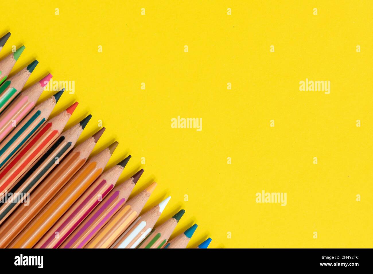 Coloring pencils isolated on yellow background close up concept with copy space for text Stock Photo