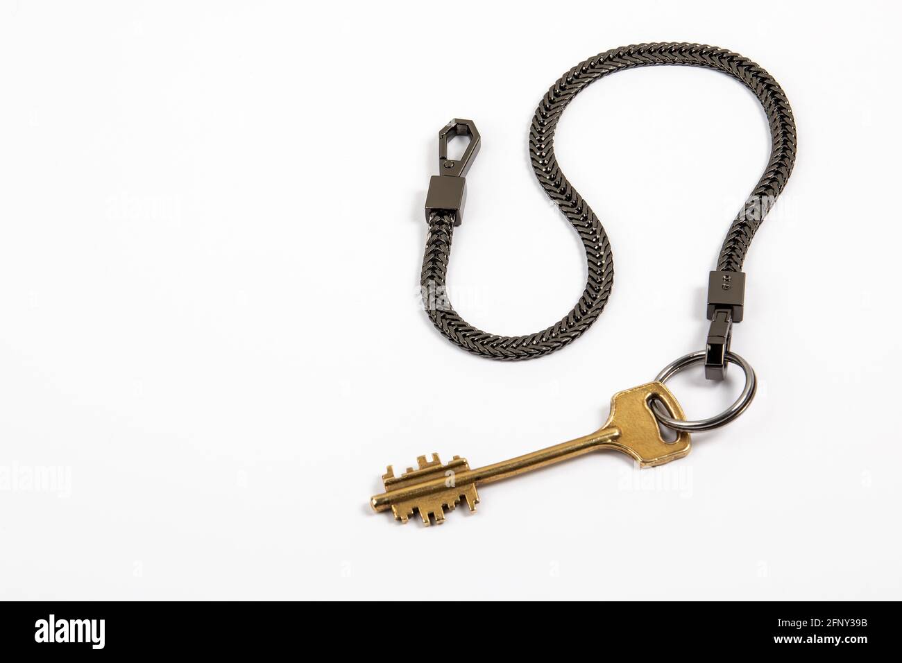 Home key with black metal chain. Copy space Stock Photo - Alamy