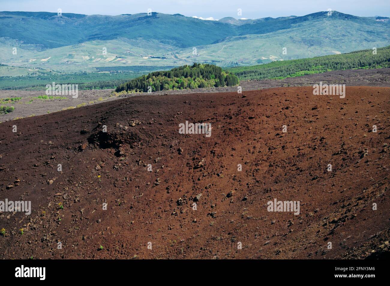 volcanic landscape in Sicily rim of old crater in Etna Park in the background the wooded Mount Egitto and the mountains of Nebrodi Stock Photo