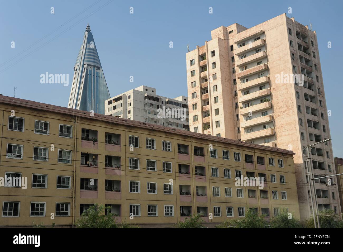 08.08.2012, Pyongyang, North Korea, Asia - Residential buildings in the city centre of the North Korean capital with the top of the Ryugyong Hotel. Stock Photo