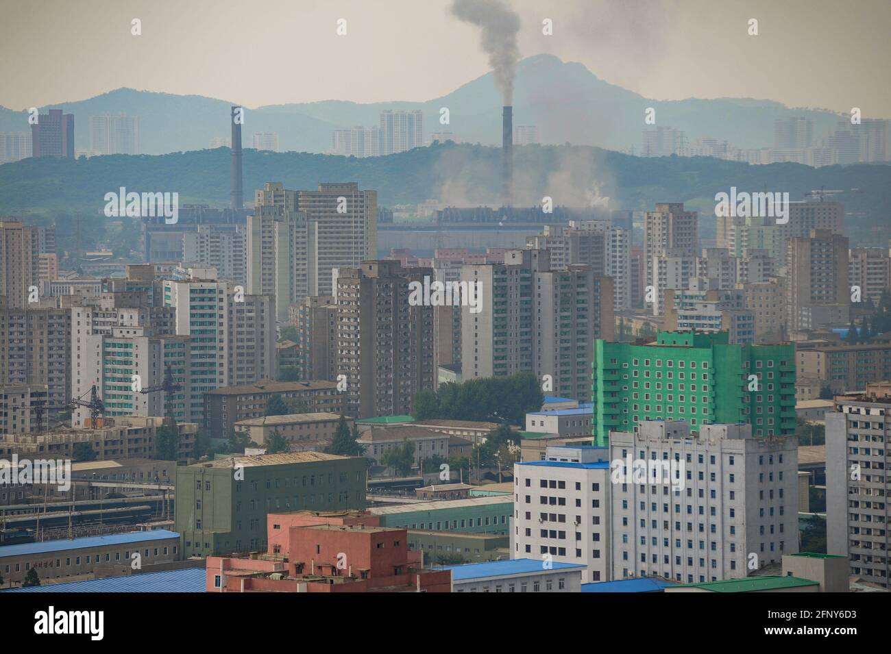 09.08.2012, Pyongyang, North Korea, Asia - Elevated cityscape shows smoking chimneys and a significant air pollution with smog over buildings. Stock Photo
