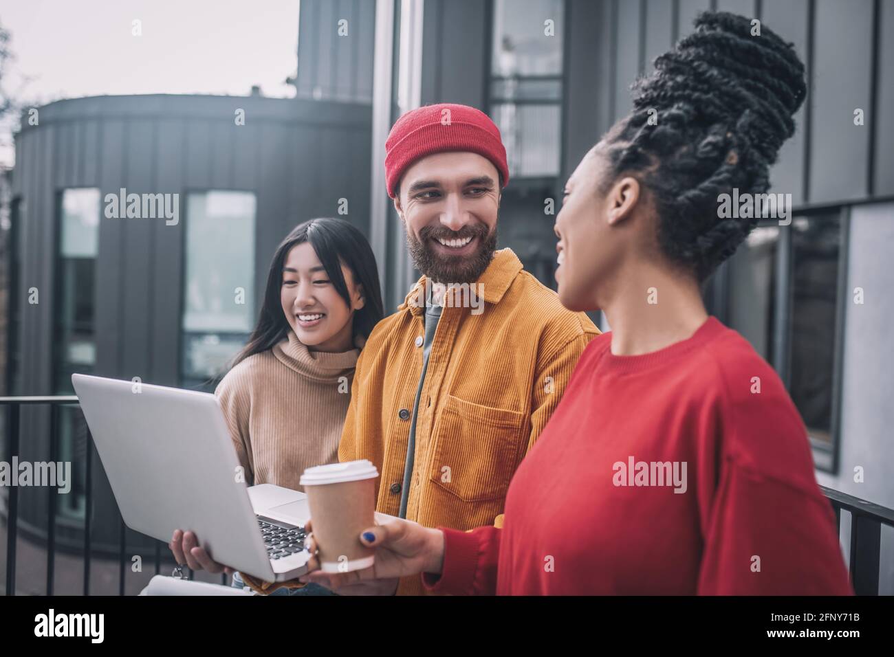 Three friends watching something online and feeling interested Stock ...