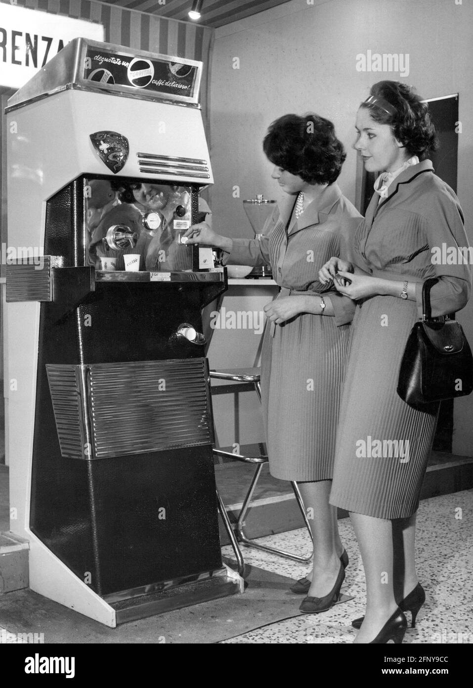 https://c8.alamy.com/comp/2FNY9CC/gastronomy-coffee-maker-two-women-testing-new-coffeemaker-by-torrital-industry-fair-milan-additional-rights-clearance-info-not-available-2FNY9CC.jpg