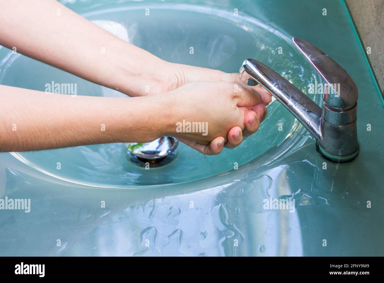 washing hand and turn off faucet out door Stock Photo Alamy
