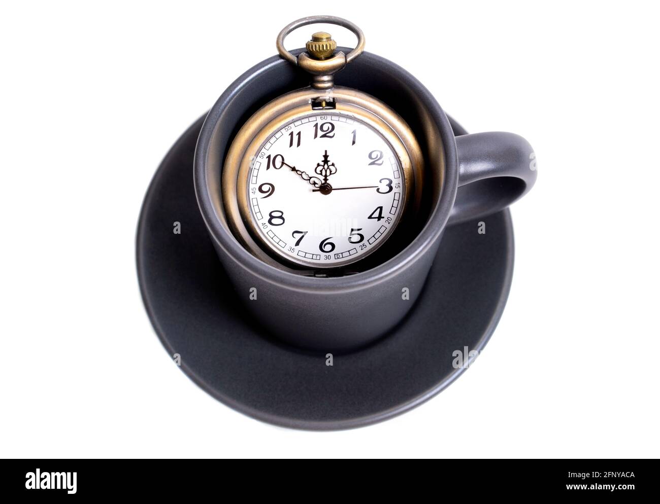 Antique pocket watch in a coffee cup isolated on white. Coffee time concept. Stock Photo