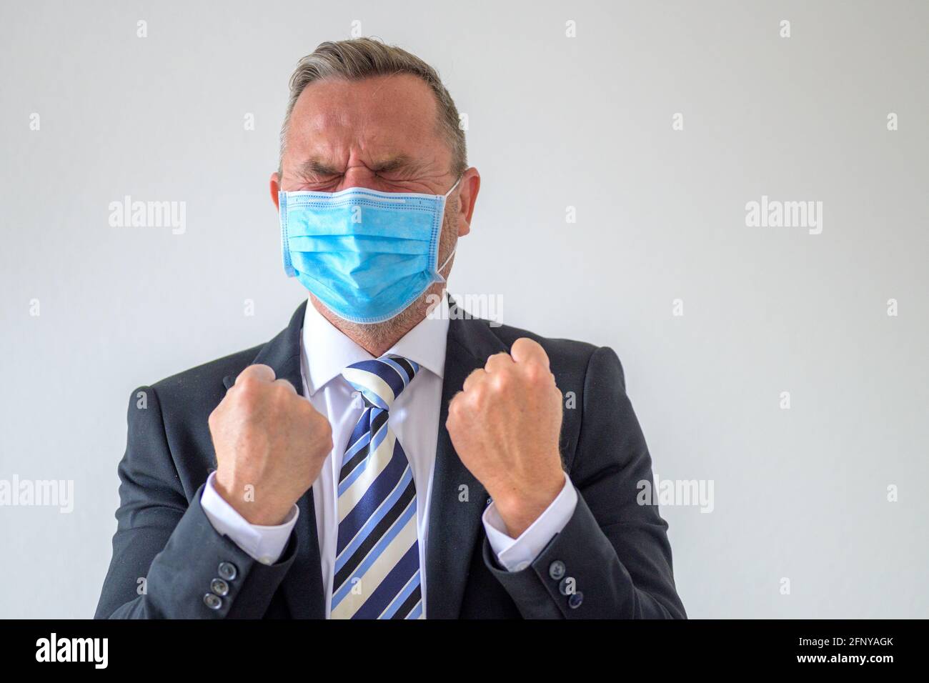 Anguished businessman wearing a face mask during the Covid19 pandemic