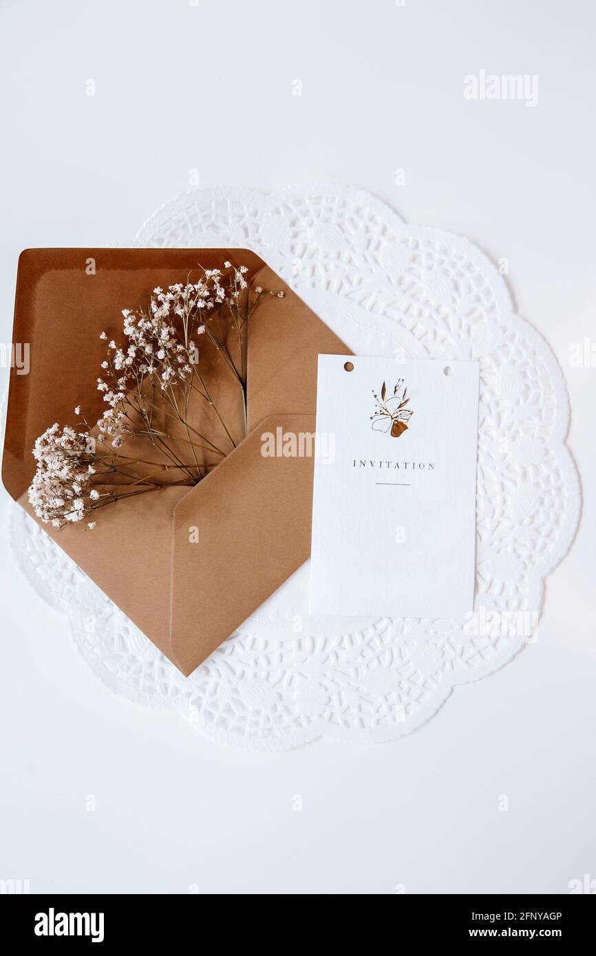 Brown envelop filled with flowers for wedding, birthday, or graduation. Mood and lifestyle pictures for Instagram and Pinterest Stock Photo