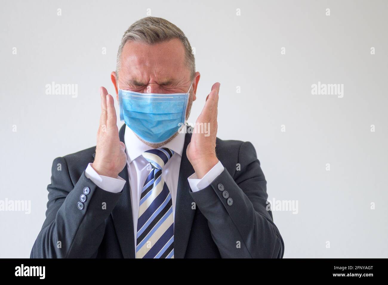 Anguished businessman wearing a face mask during the Covid19 pandemic