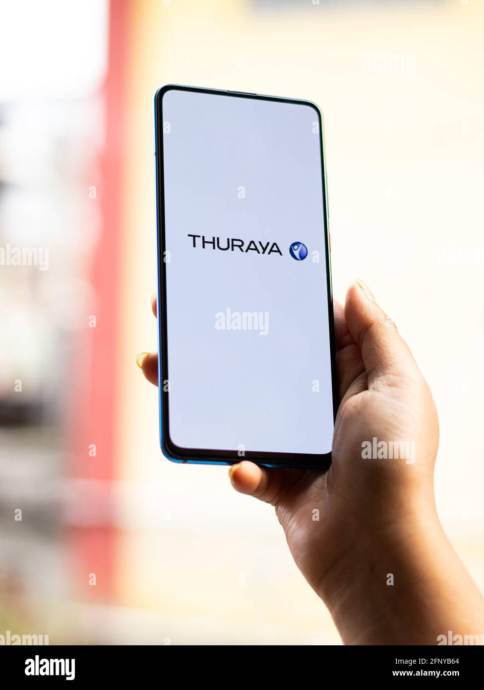 Assam, india - May 18, 2021 : Thuraya logo on phone screen stock image. Stock Photo