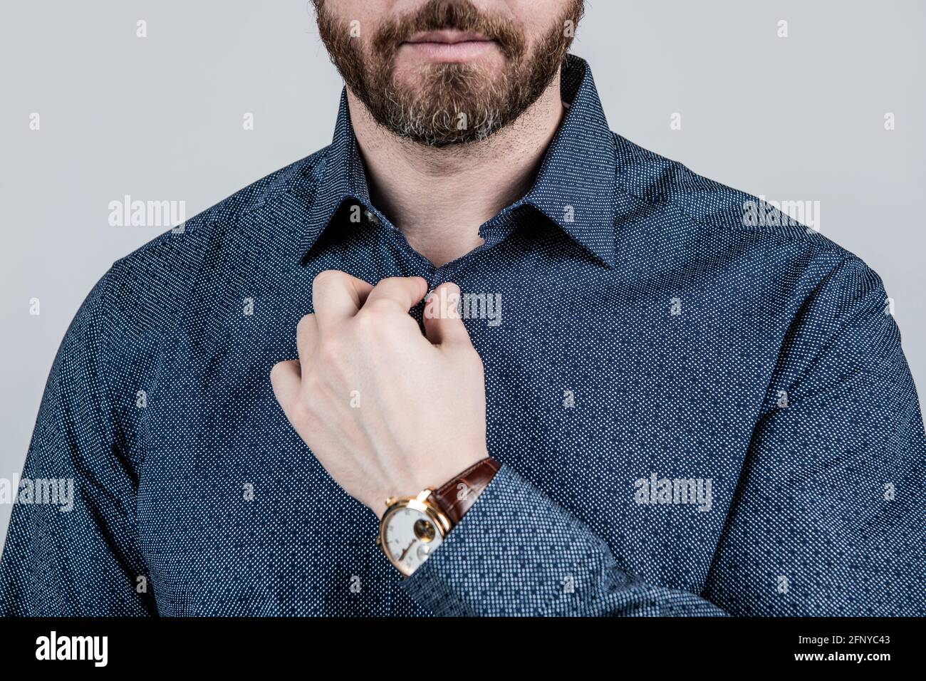 Bearded man cropped view button casual style shirt grey background, dressing informal Stock Photo