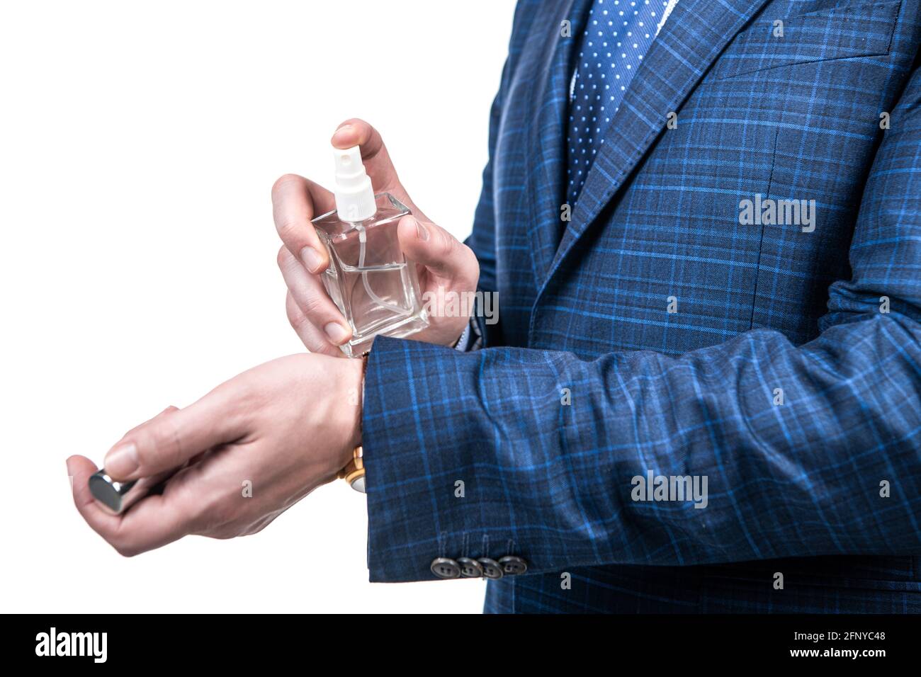 Professional man cropped view apply perfume liquid on wrist, masculine scent Stock Photo