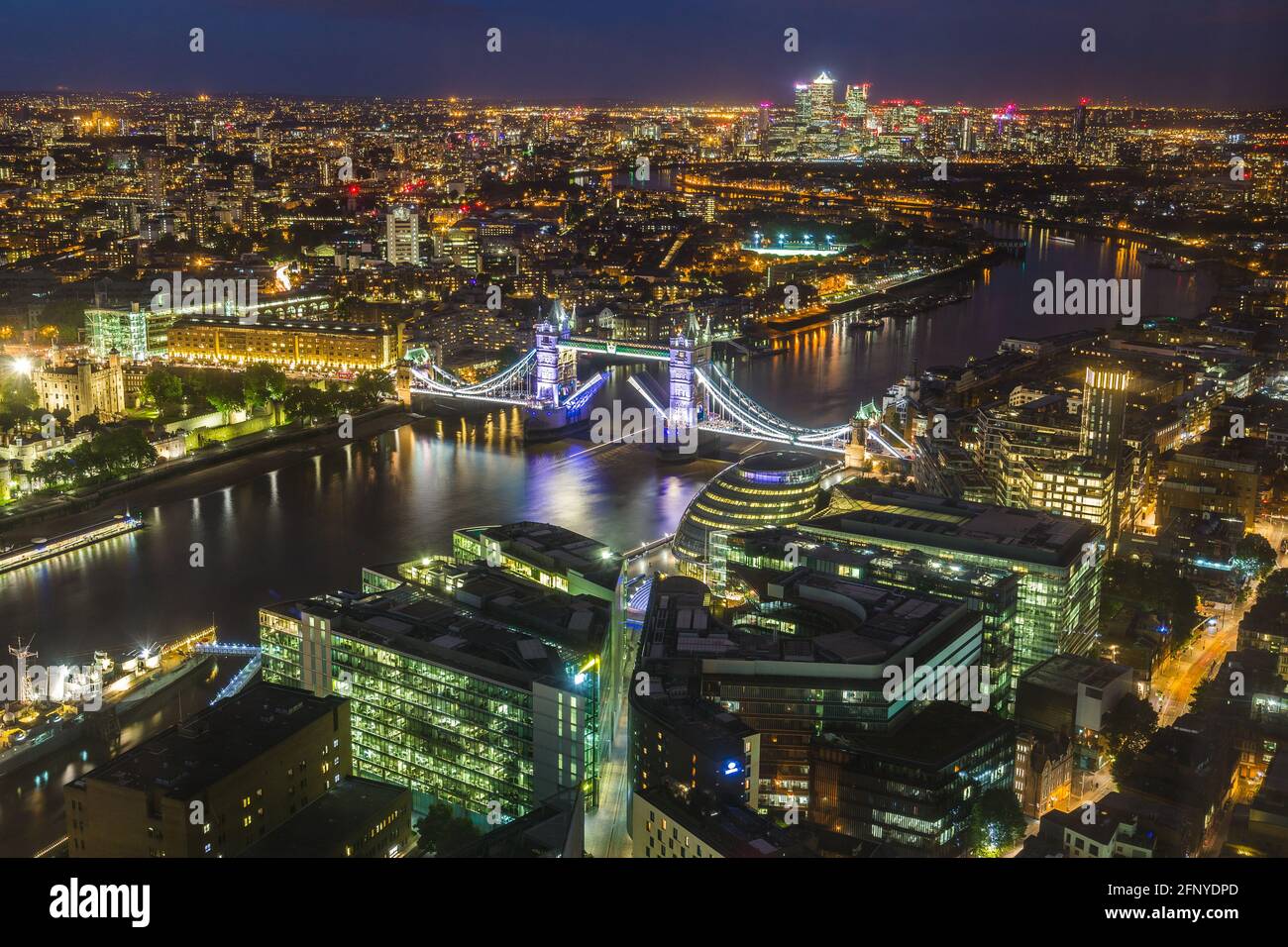 London skyline at night with illuminated architecture and landmarks such as Tower Bridge Stock Photo