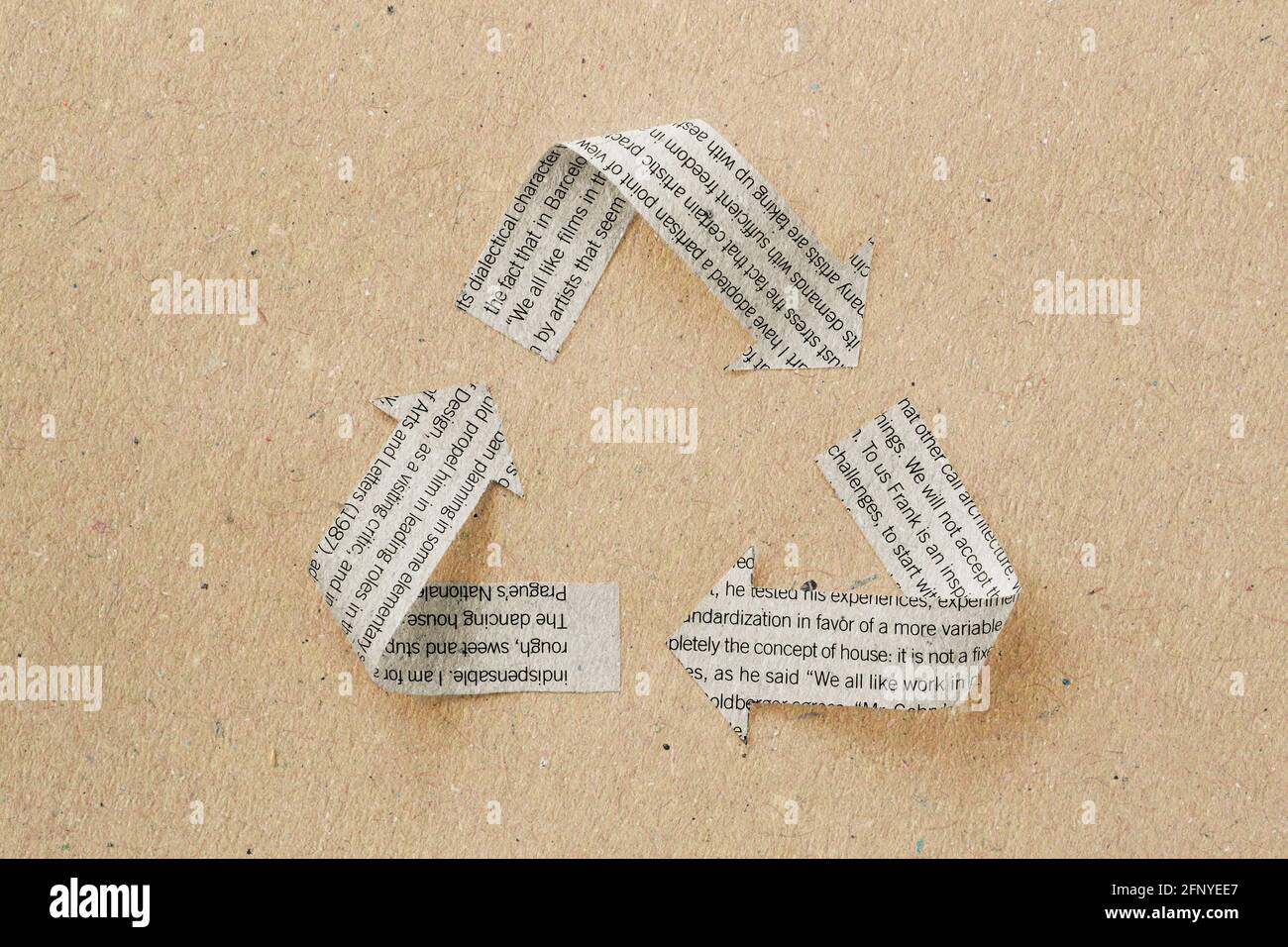 Recycle symbol made with newspaper sheet on recycled paper - Ecology and recycling concept Stock Photo