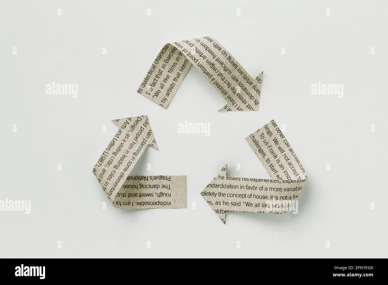 Recycle symbol made with newspaper sheet on white background - Ecology and recycling concept Stock Photo