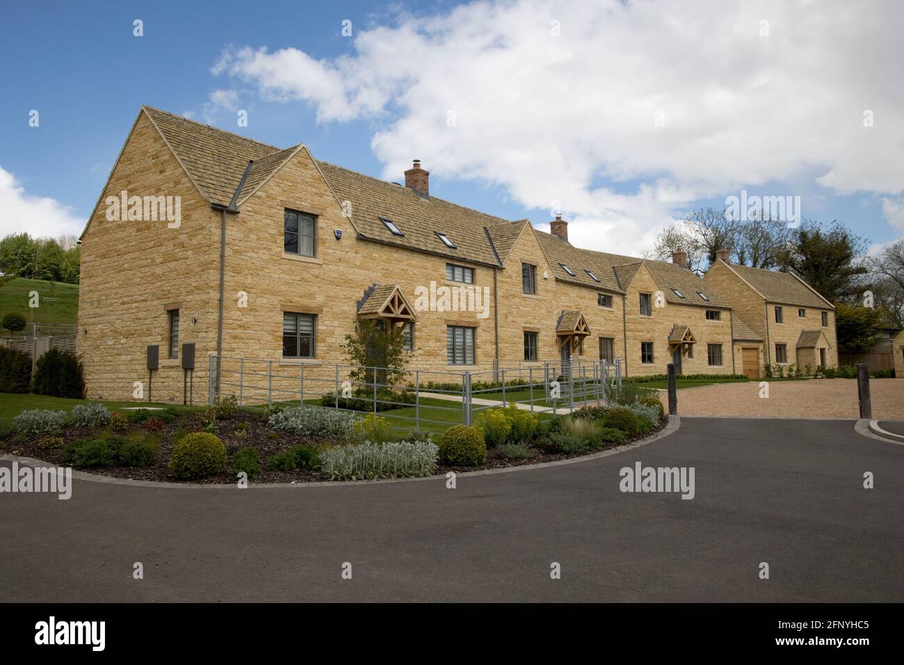 Attractive linked traditional new Cotswood stone houses in rural setting Chipping Campden UK Stock Photo