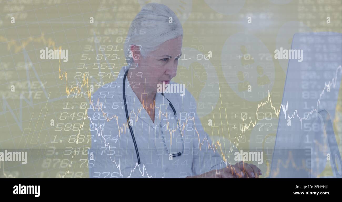 Financial data processing over doctor typing on a computer, economy and healthcare concepts Stock Photo