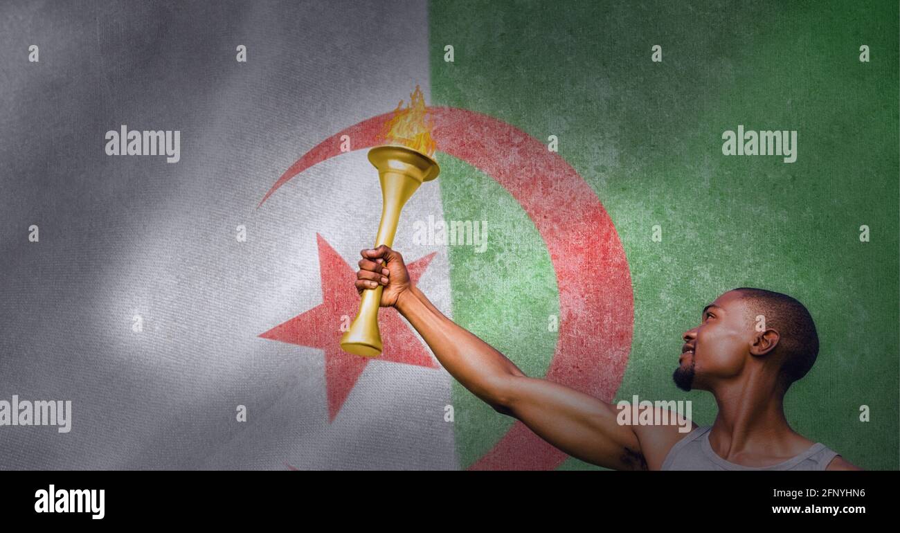 Man holding olympic torch over algerian flag, olympic games and sports event concept Stock Photo