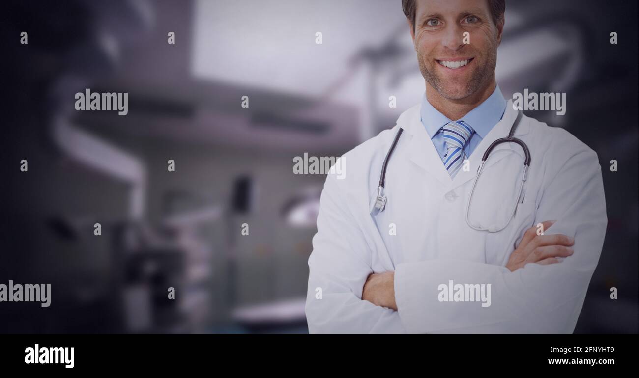 Portrait of caucasian male doctor with arms crossed smiling against ...
