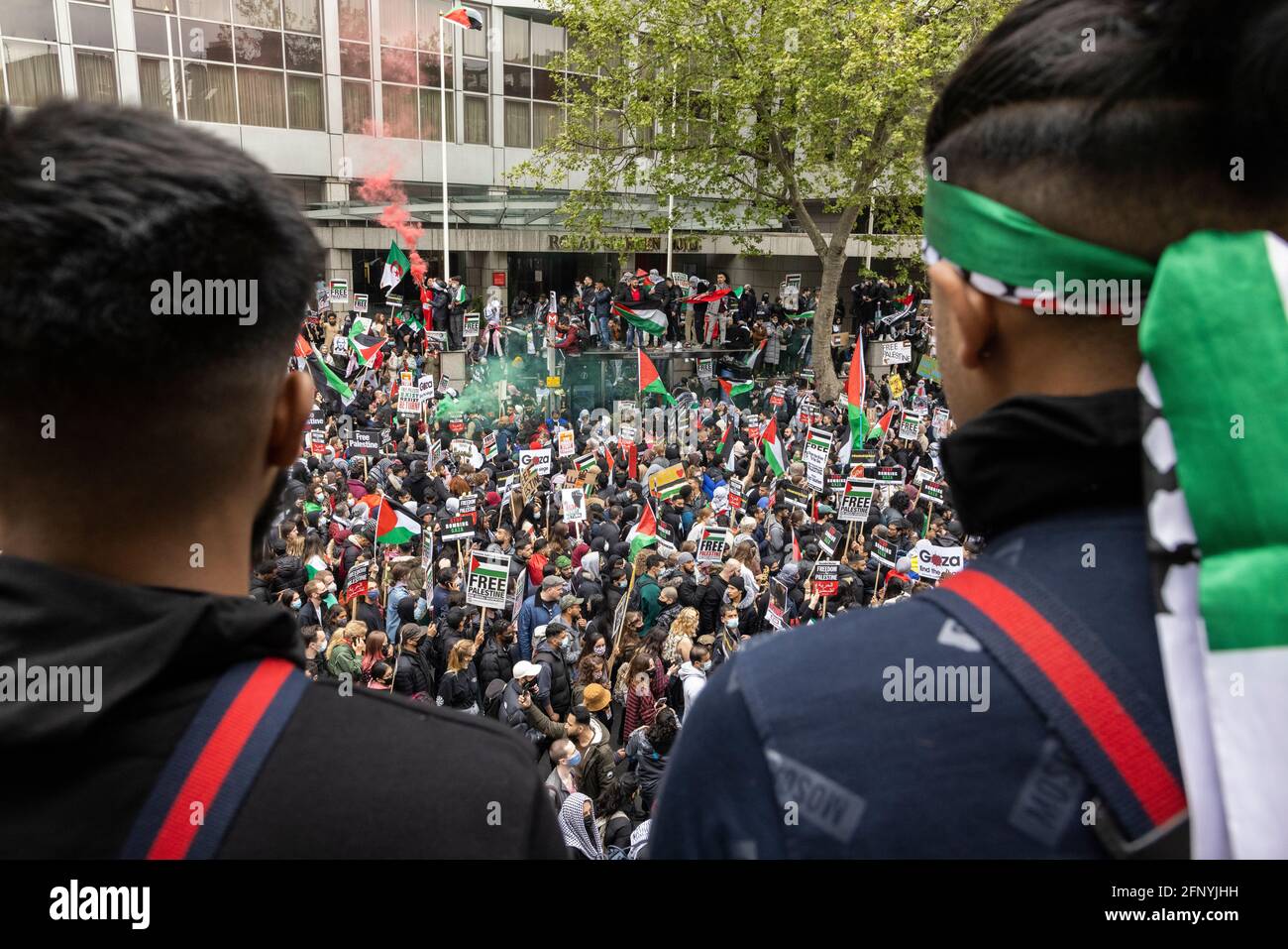 Two protesters looking down on crowd from above, 'Free Palestine' solidarity protest, London, 15 May 2021 Stock Photo