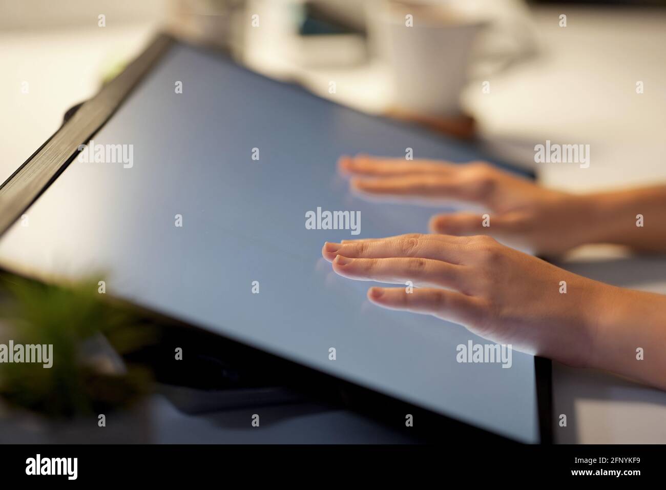 hands on led light tablet at night office Stock Photo