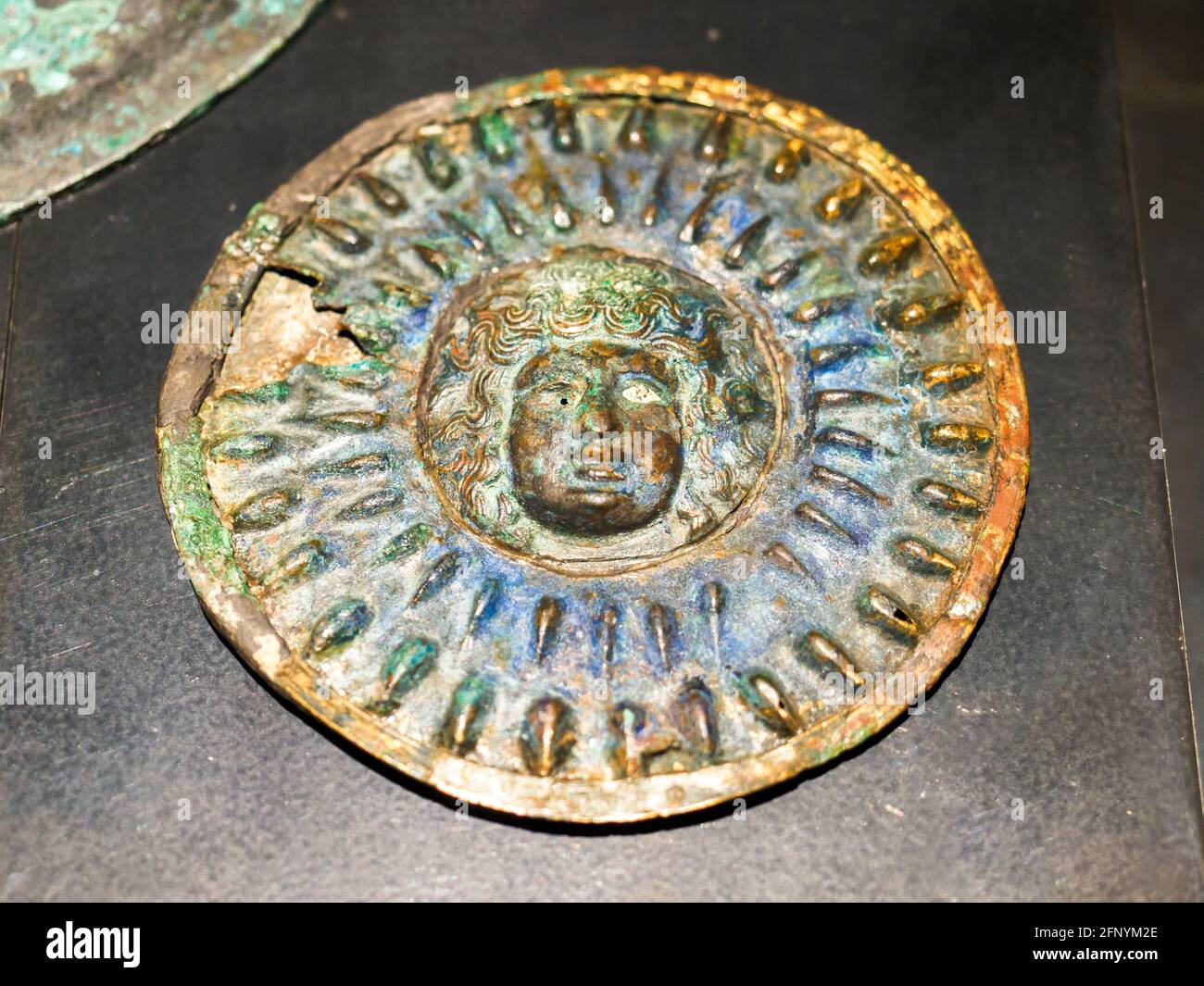 Silver mirror with bronze relief decoration depicting Medusa - Pompeii archaeological site, Italy Stock Photo