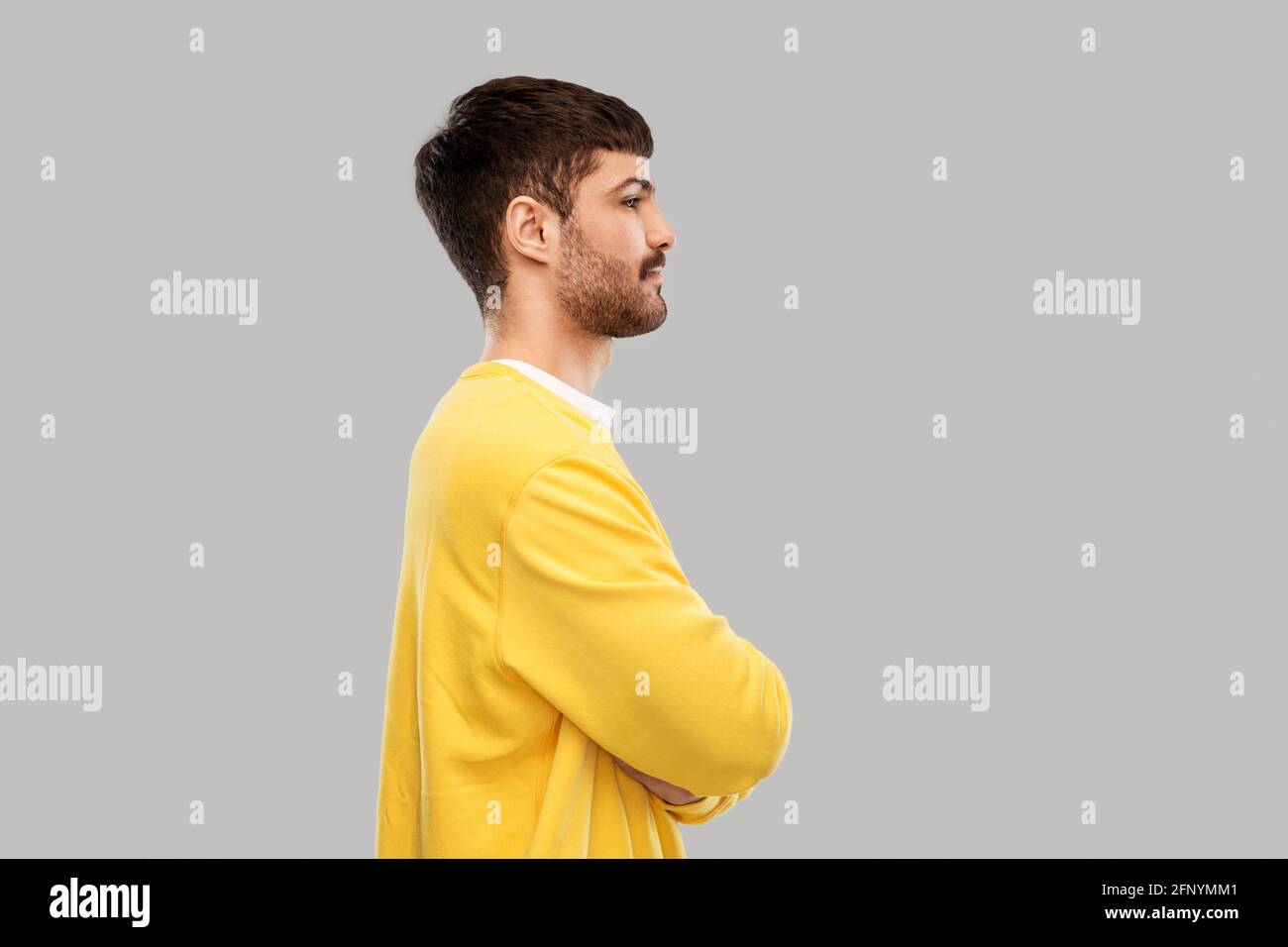 Young man side view crossed arms hi-res stock photography and images ...