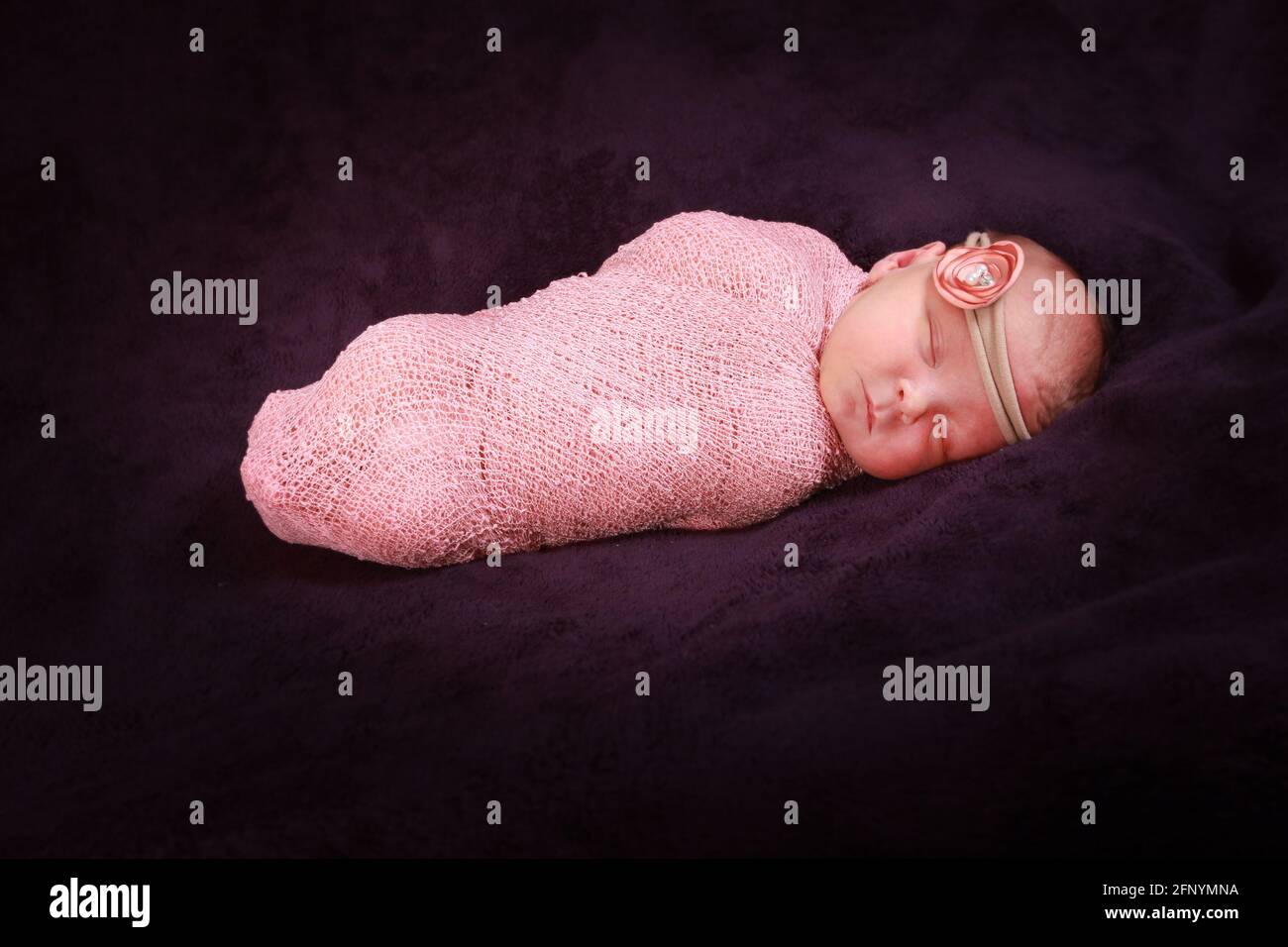 baby girl sleeping in a blanket, 10 day old baby girl Stock Photo