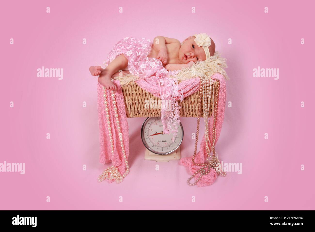 baby girl 10 days old asleep on baby scales, newborn baby Stock Photo