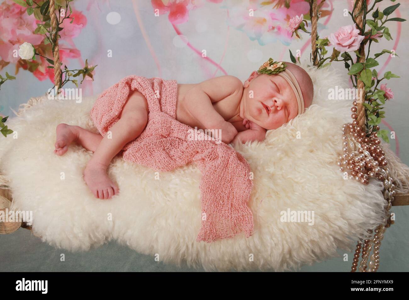 baby girl on asleep on a decretive swing, beautiful baby Stock Photo