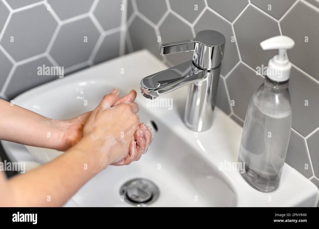 close up of woman washing hands with liquid soap Stock Photo