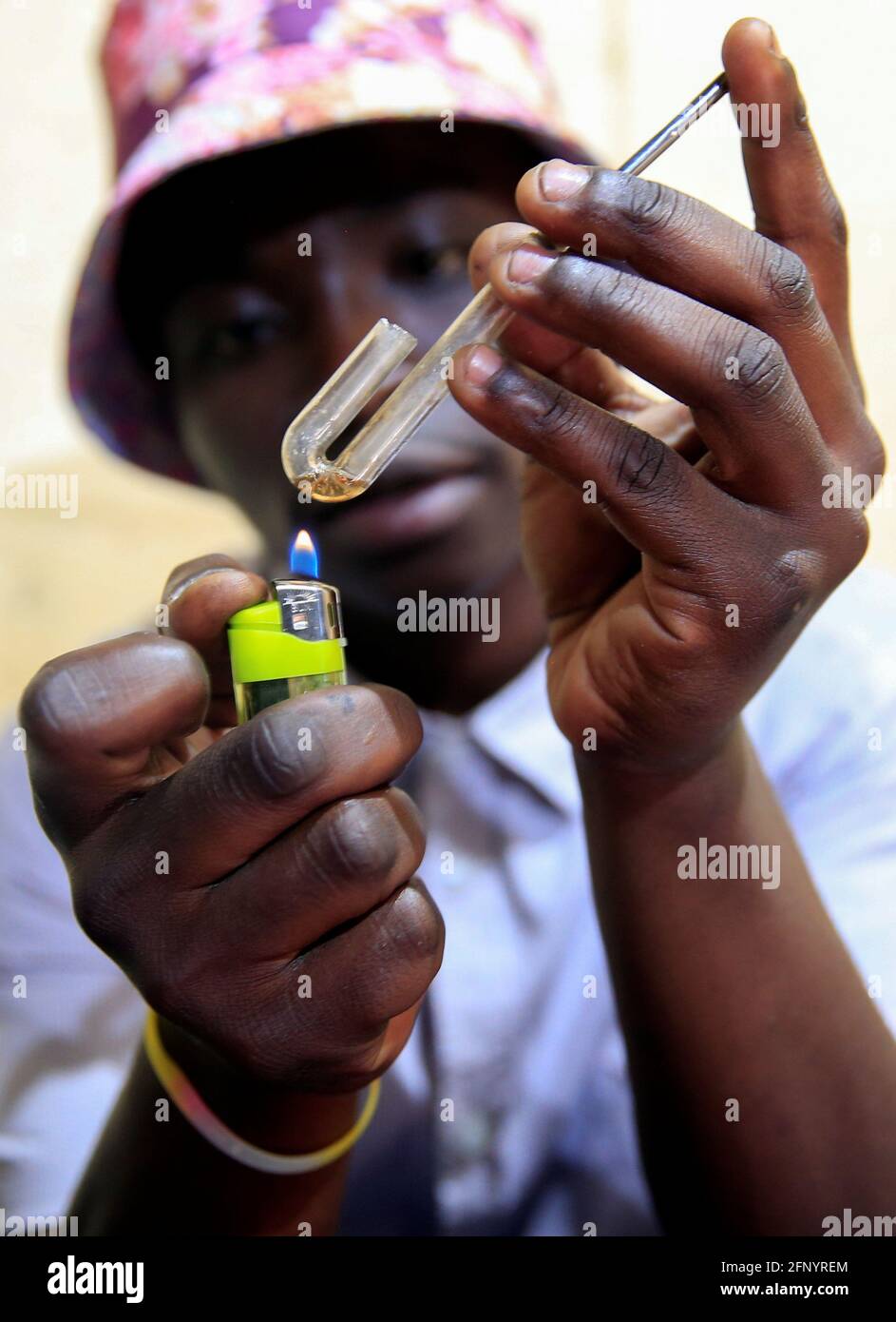 A Drug User Prepares A Crystal Methamphetamine Smoke In The High Density Suburb Of Mabvuku In