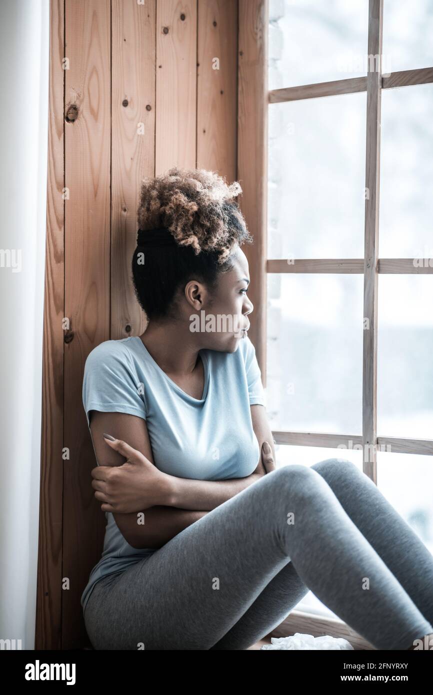 Lonely sad woman looking out window on windowsill Stock Photo - Alamy