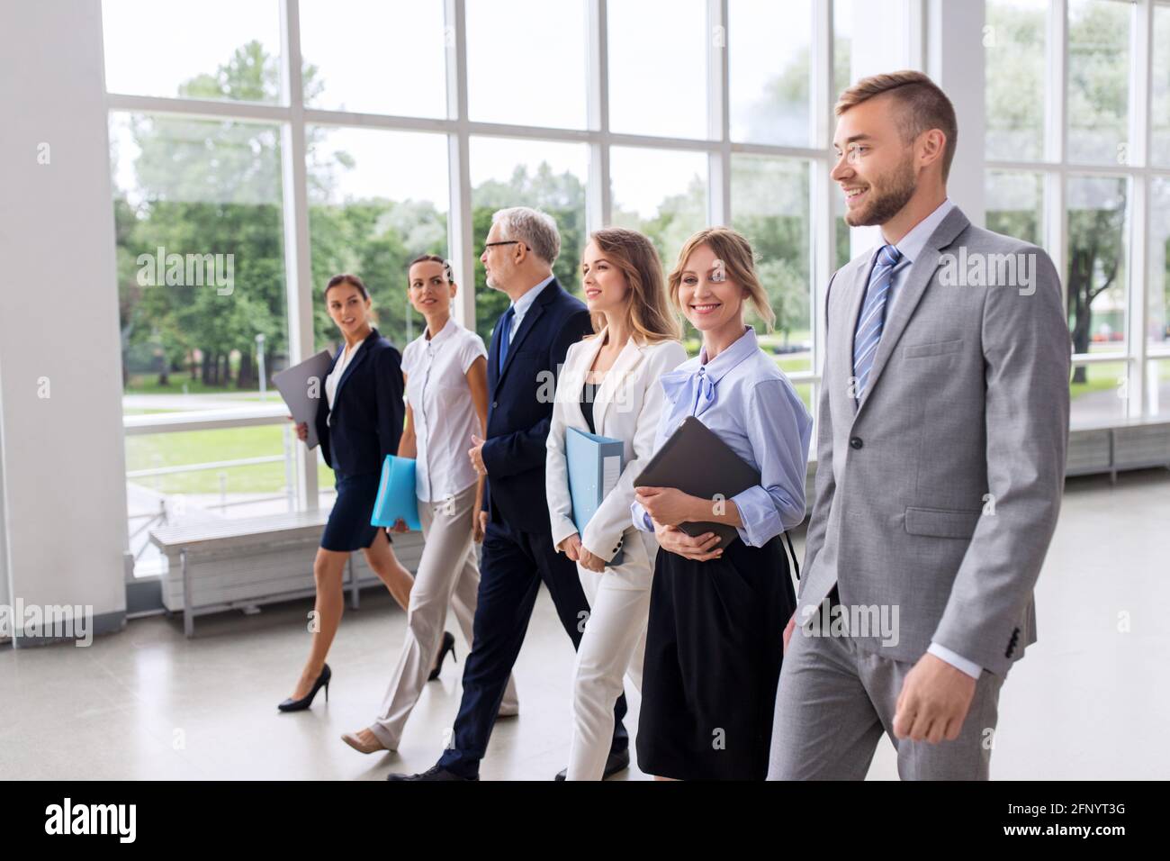 business people walking along office building Stock Photo - Alamy