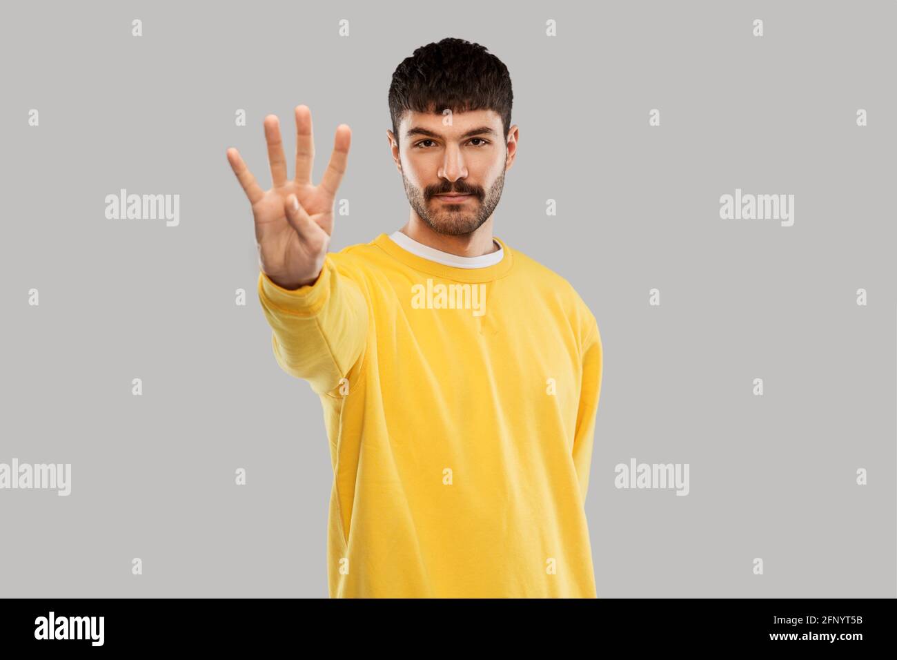 Male hand showing four fingers hi-res stock photography and images - Alamy