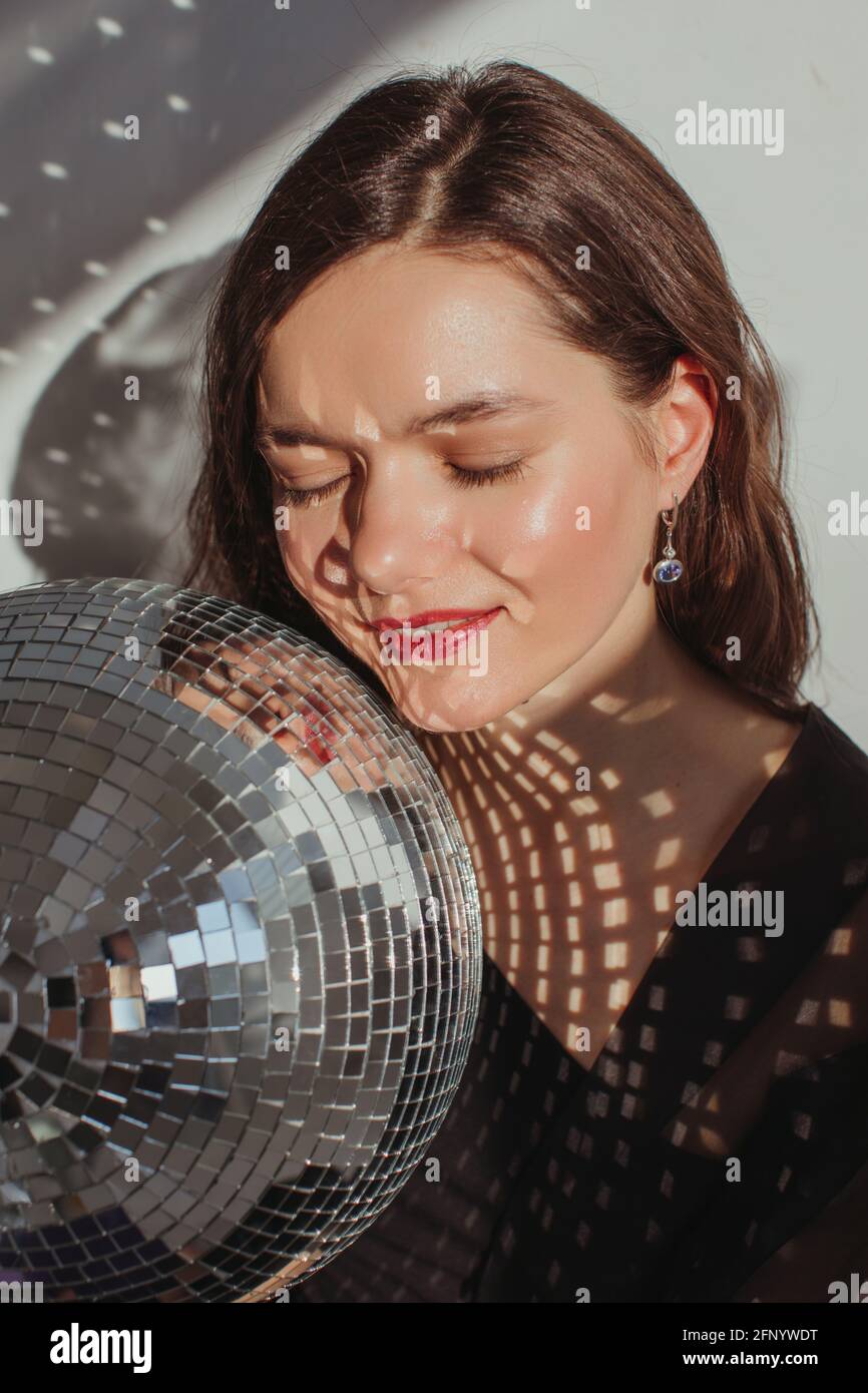 Portrait of a woman holding a glitter ball Stock Photo
