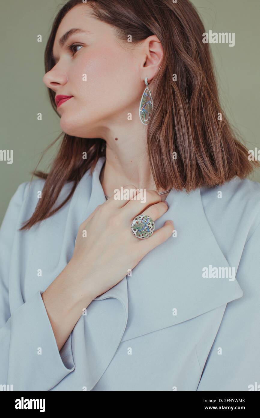 Portrait of a beautiful woman with her hand on her neck Stock Photo