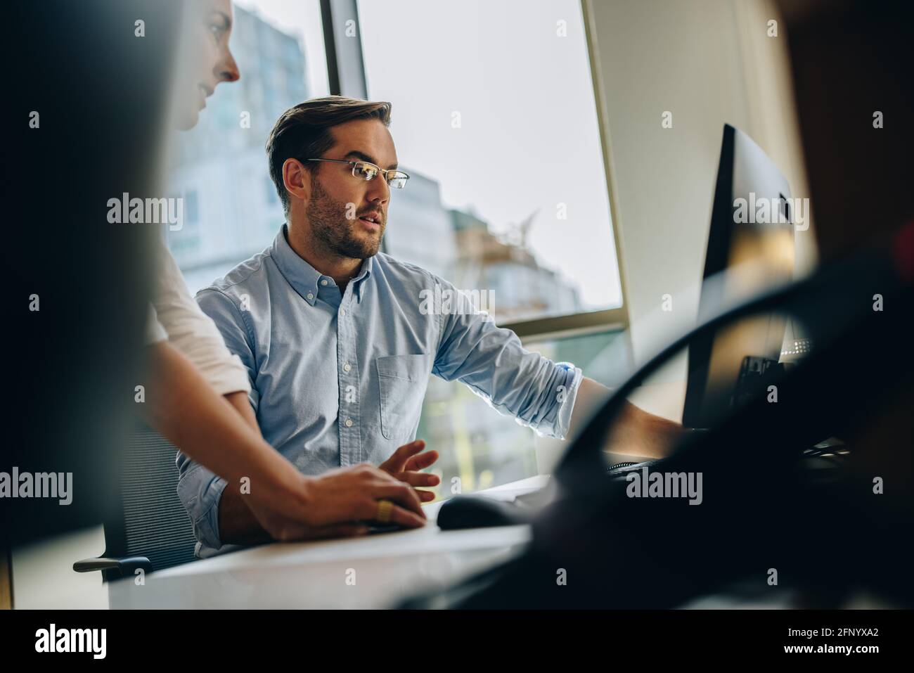 Manger helping coworker working on new project. business people working together in computer. Stock Photo