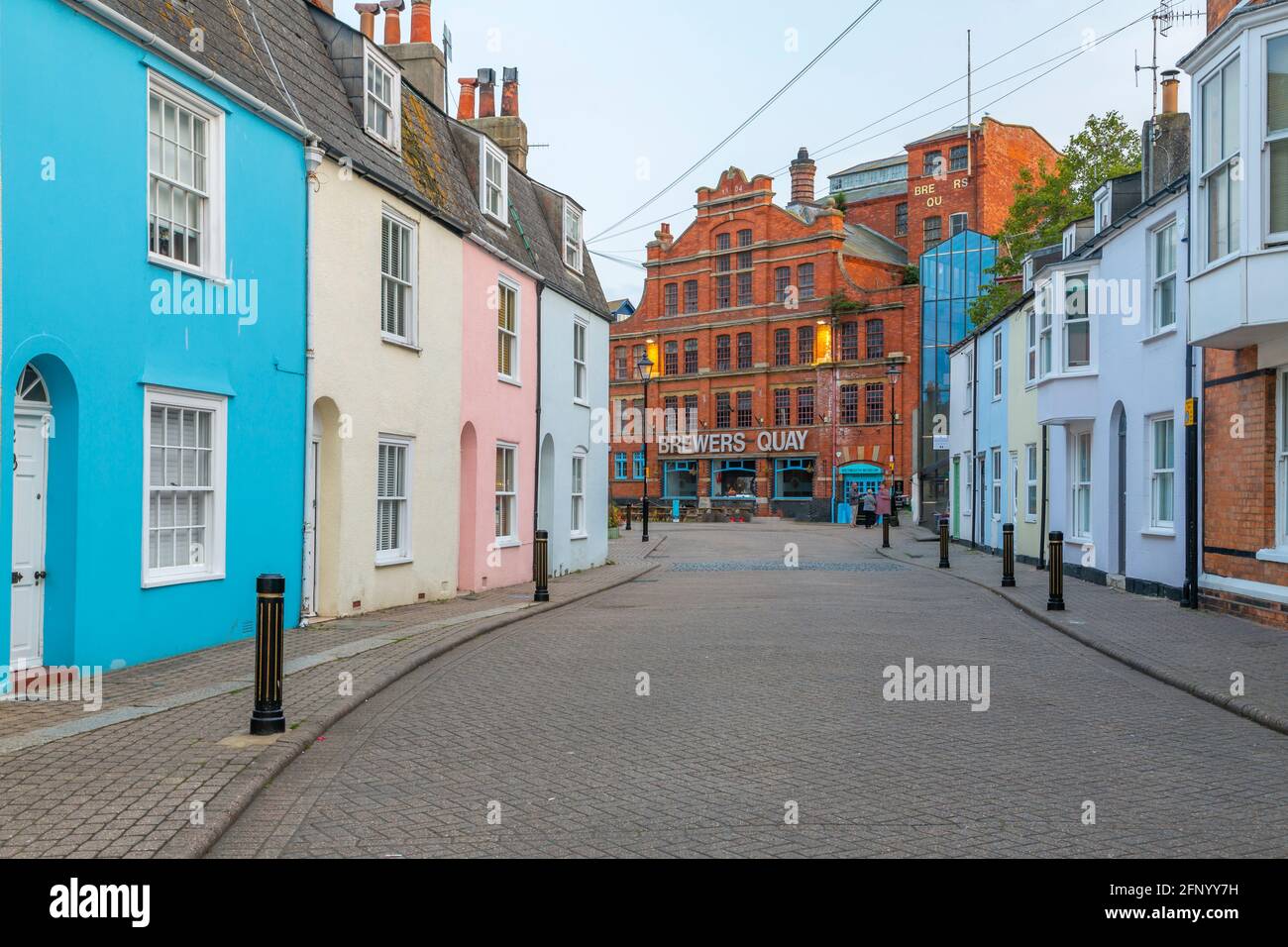 View of colourful houses leading to the Brewers Quay at dusk, Weymouth