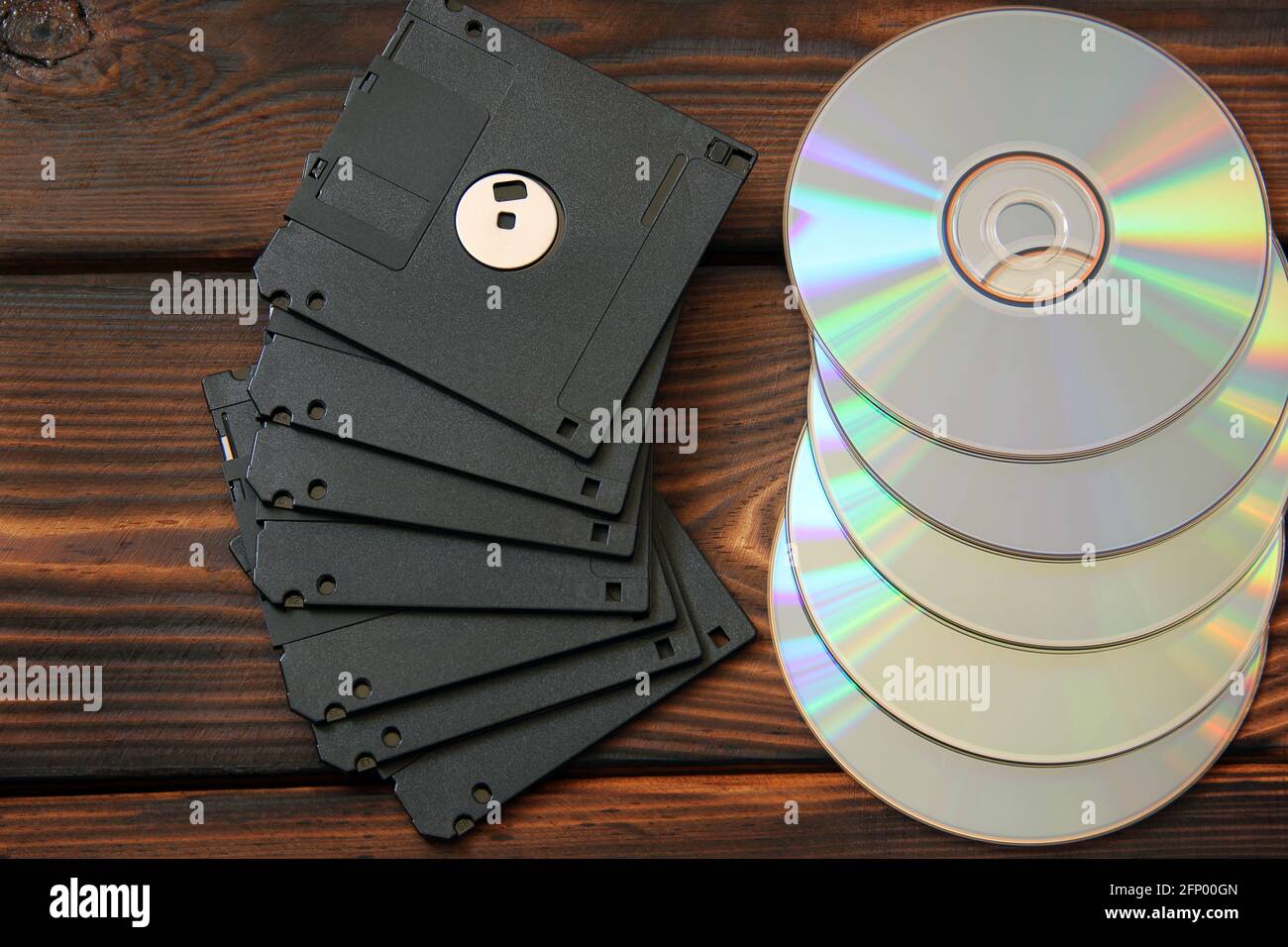 Floppy disks and disks on wooden background Stock Photo